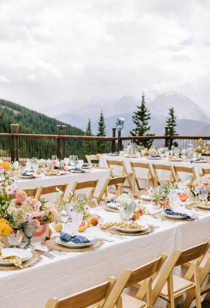 Outdoor wedding reception at The Little Nell in Aspen, Colorado with the Rocky Mountains in the distance.