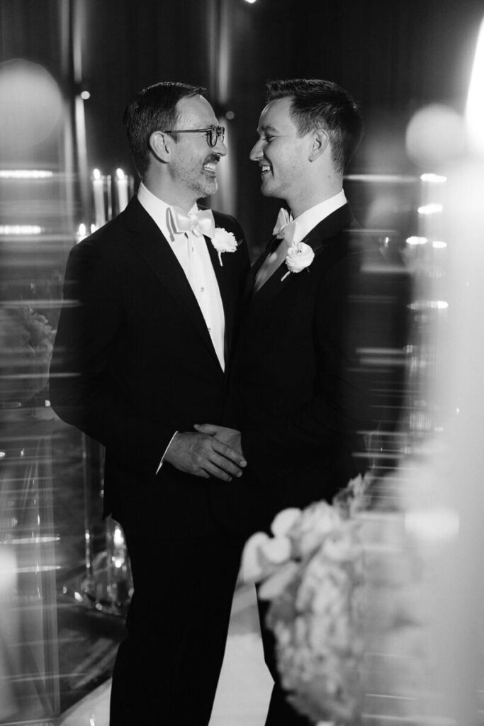 Groom and groom portrait at the Ritz Carlton Dallas, with both in a black tuxedo