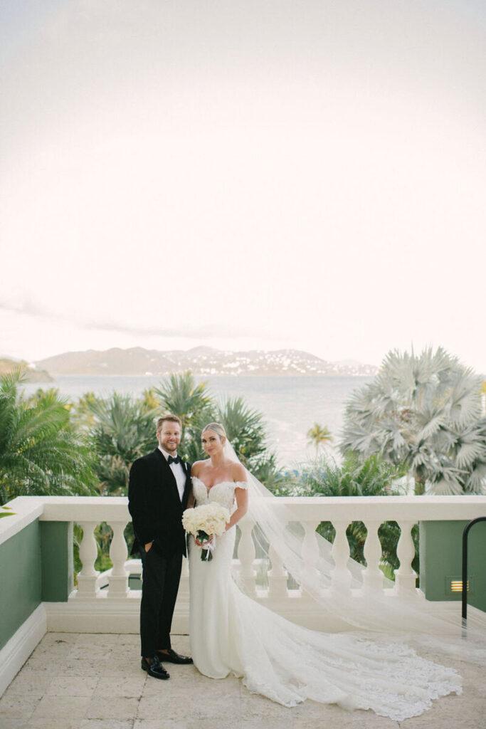 Bride and groom standing on a patio overlooking the ocean in St. Thomas