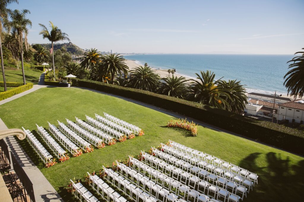 Outdoor ceremony at Bel Air Bay Club in Los Angeles, with guests facing the Pacific Ocean on the lawn